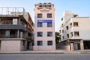 a tall building with a too variables sign on it at FabHotel Destination 42 - Nr Pheonix Mall in Kharadi
