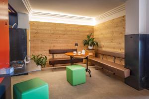 a conference room with wooden walls and a table and benches at Ambienthotel Spiaggia in Malcesine