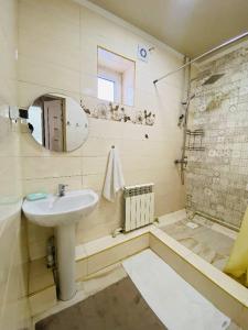 a bathroom with a sink and a shower at Guest house Nuri in Karakol