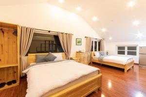 a bedroom with two beds in a room at Cherry Luxury Hotel in Da Lat