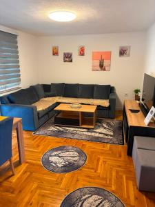 a living room with a couch and a table at Family Private House w Garden & Gazebo 10 Guests in Sarajevo