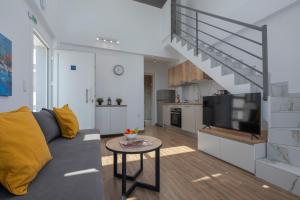 a living room with a couch and a tv at SLV Irida Apartment in Ofrínion +10 photos
