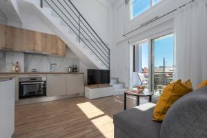 a living room with a couch and a kitchen at SLV Irida Apartment in Ofrínion