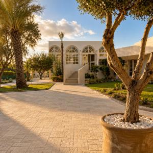 a building with a tree in front of it at Hôtel Archipel in Monastir