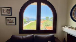 a large window in a living room with a couch at Casa De Sol by Horizon Homes in Ofrínion