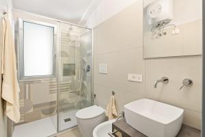 a bathroom with a toilet and a glass shower at Sabbiamare Torre dei Corsari in Torre Dei Corsari +19 photos