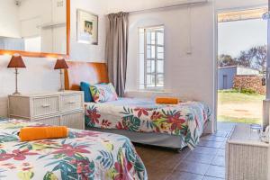 a bedroom with two beds and a window at The Hangklip Hotel in Pringle Bay +113 photos
