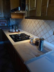 a kitchen with a stove and a counter top at Casal Pedrajás in Muxia