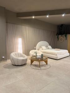 a living room with two beds and a coffee table at BREATH47SPA - Private Spa Suite White Jacuzzi & Sauna in Marbella in Marbella