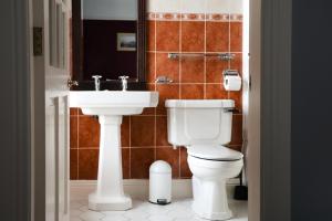 a bathroom with a toilet and a sink at Hydro Hotel in Lisdoonvarna