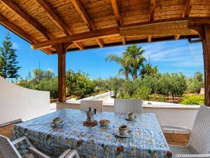 a table and chairs on a patio at Villa Mele in Lido Marini