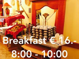 a sign for a breakfast room with a table with cups at Bed & Breakfast du Château - Breakfast not included in Vianden
