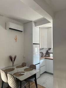 a dining room with a table and chairs in a kitchen at Lux stan in Bar
