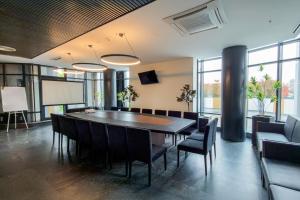 a conference room with a table and chairs at Hotel Rubin DHS in Kruševac