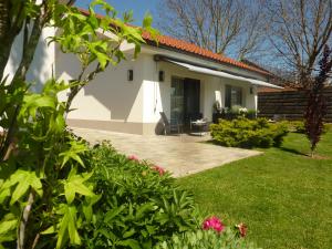 a small white house with a yard at Rooms Gašper 1 in Postojna