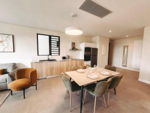 a kitchen and dining room with a table and chairs at Asmara Residence 2 Bedroom Apartment by LOV Mauritius, Beach Access in Petite Case Noyale