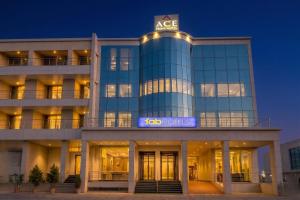 a building with a aco hotel sign on it at FabHotel Ace Prime in Greater Noida