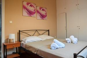 a bedroom with two beds with towels on them at BotaniCasa by WENS in Preveza