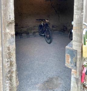 a bike parked in a cave with a bench at Gîte du Gacet in Trévérien