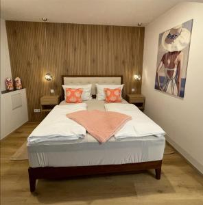 a bedroom with a bed with white sheets and orange pillows at Ferienwohnung am Entenplatz in Eltville
