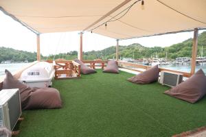 a boat with pillows and a tent on the water at Phinisi Private trip Komodo Island in Komodo Labuan Bajo Airport