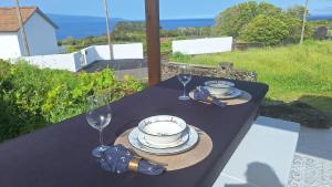 a black table with glasses and plates on it at Adega do capitao in Piedade