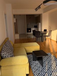 a living room with a couch and a table at Skopje Riverfront Modern Apartment in Skopje