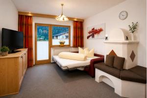 a hotel room with a bed and a tv at Top Tirol Appartement in Längenfeld +28 photos