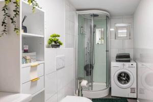 a bathroom with a shower and a washing machine at Schöne Wohnung in ruhiger Gegend in Calden +29 photos
