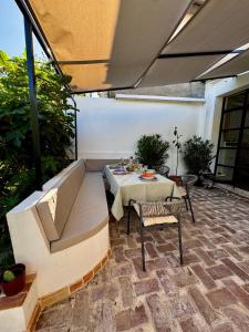 a patio with a long couch and a table at Exceptional Home-5 min from Porto Montenegro Tivat in Tivat