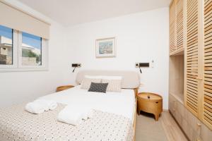 a white bedroom with a bed and a window at Residence Giardino in Ugljan +26 photos