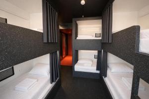 a group of bunk beds in a room at AMISTAT Hub Hostel Budapest in Budapest