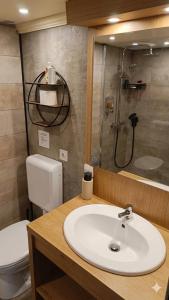 a bathroom with a sink and a shower and a toilet at Beach apartment - Ocean sunset full view in Meschers-sur-Gironde +52 photos