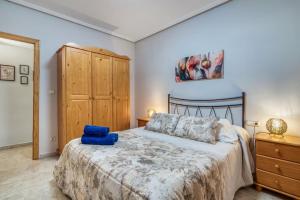 a bedroom with a bed and a wooden cabinet at CaTere Estancia Bocairent in Bocairent
