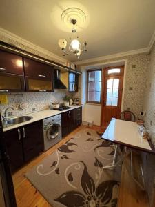 a kitchen with a sink and a dishwasher at Lankaran house in Lankaran