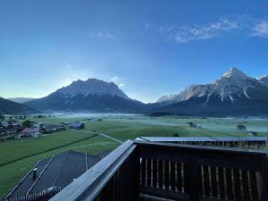 a view of a mountain range from a balcony at Zugspitzblick - pur! in Lermoos