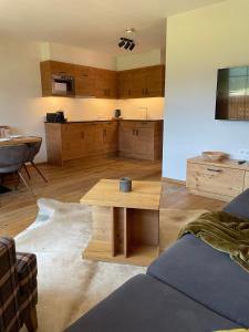 a living room with a table and a kitchen at Zugspitzblick - pur! in Lermoos +37 photos