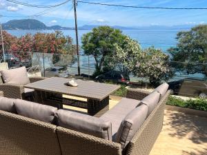 a patio with a table and chairs and a view of the ocean at Boukari Blu Studio Boukari Beach in Boukari