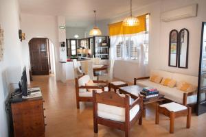 a living room with a couch and a table at EMPHASIS Traditional House with Jacuzzi & Bicycles in Apodhoúlou