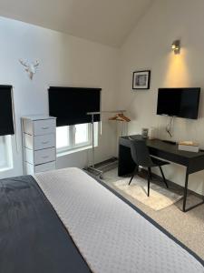 a bedroom with a bed and a desk with a computer at Week end à Spa in Spa
