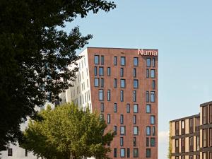 a building with a niner sign on the top of it at Numa Amsterdam Docklands in Amsterdam