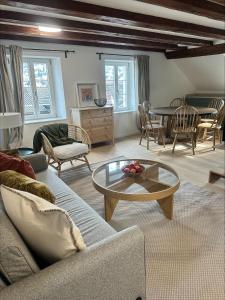 a living room with a couch and a table at Stadtloft Suites Richterswil in Richterswil
