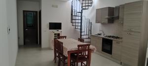 a kitchen with a table and chairs and a stove at Casa Vacanze Sofì in Ascea