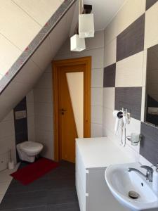 a bathroom with a sink and a toilet at Apartament u SKOCZKA in Poronin +11 photos