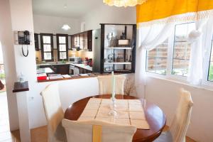 a dining room with a table and a kitchen at EMPHASIS Traditional House with Jacuzzi & Bicycles in Apodhoúlou