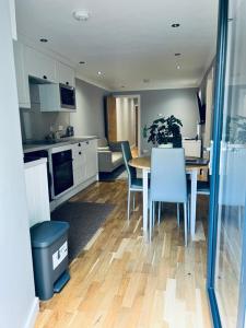 a kitchen and dining room with a table and chairs at Whiteleys Cottages 2 bedroom in Renton