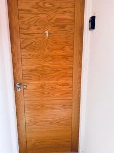 a wooden door in a white room with at Whiteleys Cottages 2 bedroom in Renton