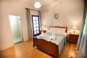 a bedroom with a bed with two towels on it at EMPHASIS Traditional House with Jacuzzi & Bicycles in Apodhoúlou