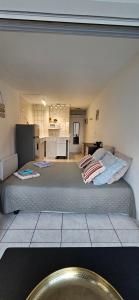 a bedroom with two beds and a kitchen at Le paradis du Port Cozy studio near port and beaches in Cap dAgde in Cap d'Agde +6 photos