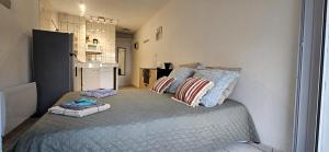 a bedroom with a bed with pillows on it at Le paradis du Port Cozy studio near port and beaches in Cap dAgde in Cap d'Agde
